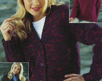 May include: A purple and black cardigan with a V-neck and button closure. The cardigan is shown on a model wearing white pants.