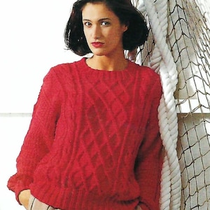 May include: A vibrant red long-sleeve sweater featuring a textured diamond cable knit pattern, a classic crew neckline, and ribbed cuffs and hem. The garment is constructed with a thick, chunky knit design that provides a structured and warm appearance.