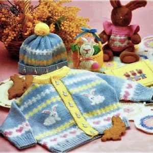 May include: A blue knitted cardigan with a yellow and white striped pattern and bunny rabbit designs. The cardigan has a button closure and is made for a baby or toddler.