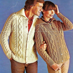 May include: A couple wearing matching cable knit cardigans. The man's cardigan is white and the woman's cardigan is brown.