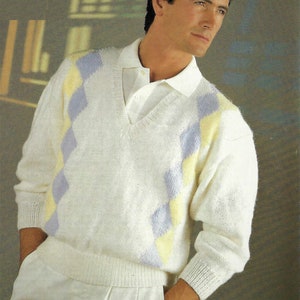 May include: A white sweater with a v-neck and a diamond pattern in yellow and purple.