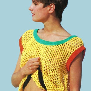 May include: A yellow crochet top with a green neckline and orange sleeve trim. The open weave design of the top is visible. The top is a sleeveless style.