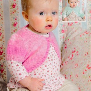 May include: A baby in a pink knitted bolero cardigan over a floral print top and cream trousers. A smaller image of the baby in a mint green bolero is in the top right. The background features a floral pattern.