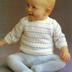 May include: A baby wearing a white and blue striped sweater with a light blue pair of tights.