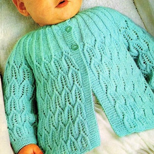 May include: A light blue knitted baby cardigan with a button closure and a delicate lace pattern.