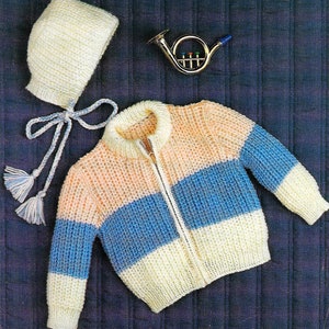 May include: A knitted baby cardigan with a zipper closure and a matching knitted hat. The cardigan is striped in peach, blue, and white. The hat has a long tie.