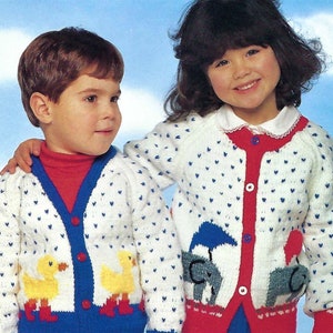 May include: Two children wearing white knit cardigans with blue and red trim. The cardigans have small blue hearts and embroidered animal appliques. The girl's cardigan has elephants and the boy's cardigan has ducks.
