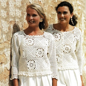 May include: Two women wearing white crocheted tops with square patterns. The tops have a scalloped neckline and long sleeves.