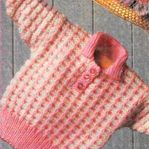 May include: A pink and white knitted sweater with a button closure. The sweater has a ribbed collar and a checkered pattern.
