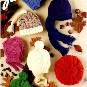 May include: A collection of seven knitted hats in various colors, including blue, white, pink, green, and red. The hats are arranged on a beige background with autumn leaves and chestnuts.