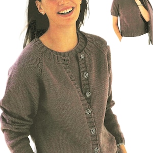 May include: A brown knitted cardigan with a button closure and a matching brown knitted top. The cardigan has long sleeves and a round neckline. The top has short sleeves and a round neckline.