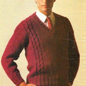 May include: A red knitted sweater with a v-neck and cable knit detail. The sweater is 34-44 inches in size.