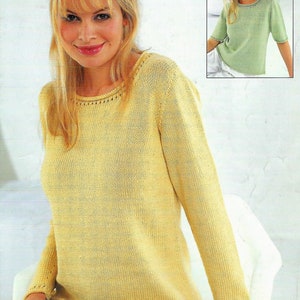 May include: A yellow knitted sweater with long sleeves and a round neckline. The sweater has a simple design and is made of a soft, lightweight yarn.