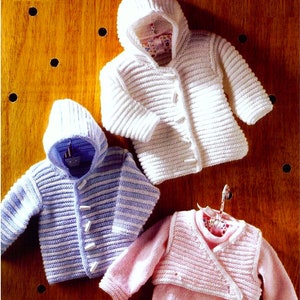 May include: Three knitted baby sweaters, one white, one blue and white striped, and one pink. All sweaters have a hooded design and button closures.