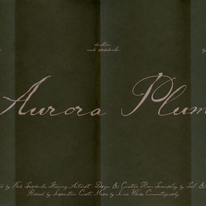 May include: A dark green background featuring the words "Aurora Plume" in a flowing, cursive font. The image also includes production credits and names of contributors, creating a minimalist aesthetic.