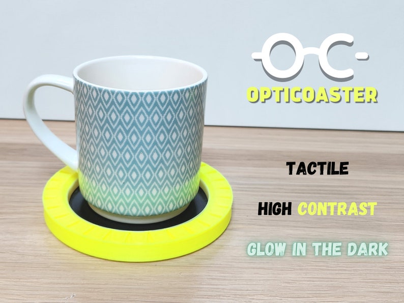 May include: A bright yellow, tactile coaster with a black center. The coaster is designed for high contrast and glows in the dark. The text "OC- OPTICOASTER" is visible in the upper right corner of the image.