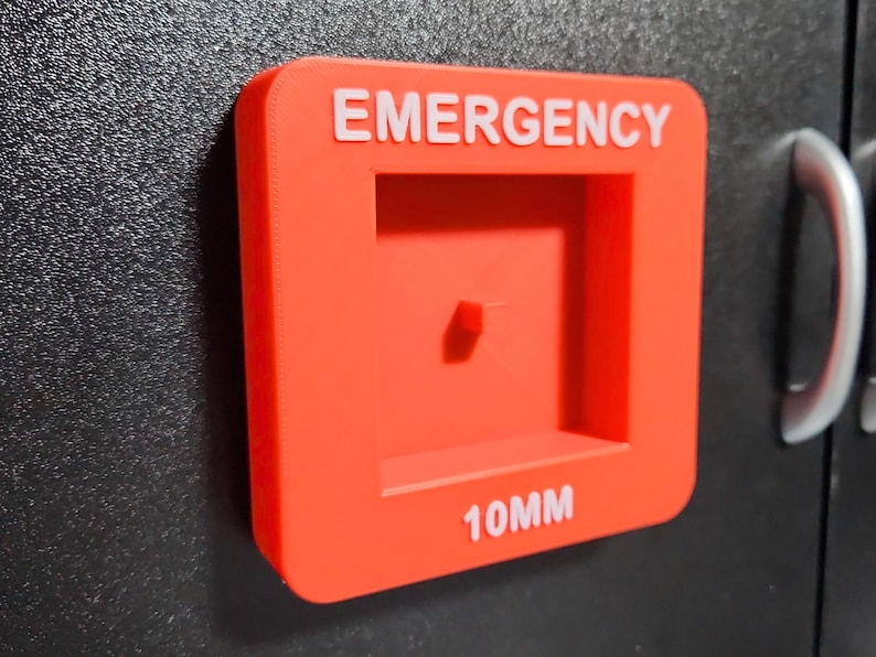 May include: A red plastic emergency box with a white label that says "EMERGENCY" and "10MM".