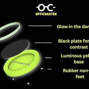 May include: A yellow luminous base with a black plate and a glow-in-the-dark ring. The base has the word "OPTICOASTER" printed on it. The base has four small rubber feet on the bottom.