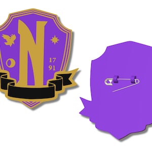 May include: Purple and gold shield-shaped pin with a gold letter N, a bird, a star, and the numbers 17 and 91. The back of the pin is purple and has a safety pin.