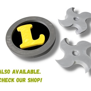 May include: A gray, circular emblem with a yellow "L" inside a black circle, and two gray, four-pointed ninja stars. The text "ALSO AVAILABLE. CHECK OUR SHOP!" is in green.