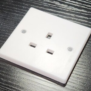 May include: A white plastic electrical outlet with three prongs. The outlet is designed for use in the United Kingdom.