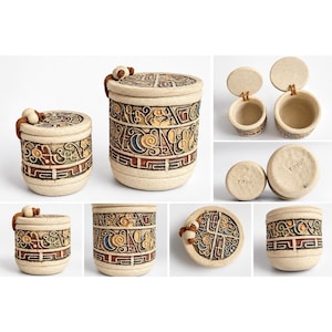 May include: Two cylindrical ceramic jars with lids, featuring textured off-white surfaces and intricate relief carvings in blue, red, and yellow. Each lid is attached with a brown leather cord and a wooden bead. The base of each jar is stamped TAYO.