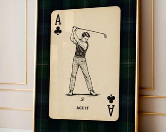 May include: A framed wall art print featuring an ace of clubs playing card design. The card displays a golfer in a plaid vest and trousers swinging a club, with the text ACE IT at the bottom. The background is a dark green and navy plaid pattern.