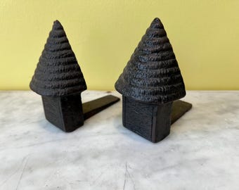 Par de cuñas para puertas de hierro fundido en forma de 'colmena'