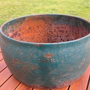 May include: A large, green cast iron pot with a handle. The pot is rusty and has the words "3 1/2 GAL" stamped on the side.