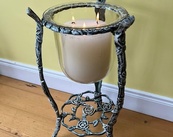 A large cast iron and glass antique indoor/outdoor candle holder/uplighter