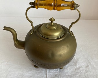 Antique brass teapot/kettle with amber glass handle and 4 bun feet