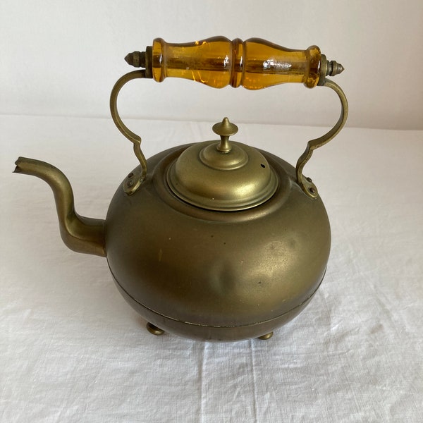 Antique brass teapot/kettle with amber glass handle and 4 bun feet