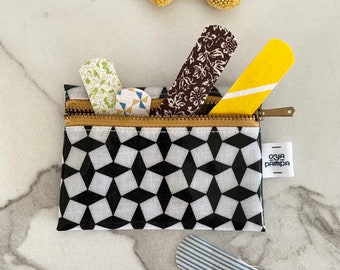 Black and white oilcloth first aid kit