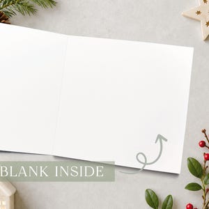 May include: A square greeting card opened to reveal a completely blank white interior. A light gray hand-drawn arrow points toward the center of the empty page. The text BLANK INSIDE is printed in white over a muted green rectangular overlay.