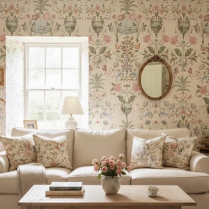 May include: A comfortable living room with a cream sofa, floral cushions, and a wooden coffee table. The walls are decorated with floral wallpaper, and a round mirror hangs above the sofa. A vase of pink roses adds a touch of colour.