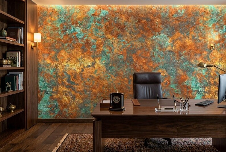 May include: An office interior featuring a large wooden desk, a black leather chair, and a textured wall with orange, teal, and gold tones. A clock, desk lamp, and computer are on the desk. Bookshelves and a patterned rug complete the scene.