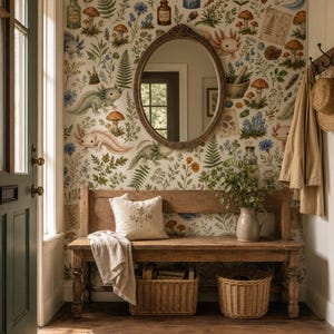 May include: A wooden bench with a cream cushion and a draped cloth, set against a wall featuring wallpaper with axolotls, mushrooms, ferns, and apothecary bottles. An oval mirror is mounted above the bench, with two wicker baskets underneath.