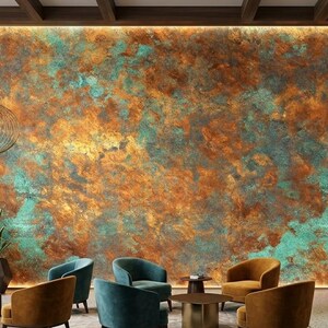 May include: A large wall panel featuring a textured, oxidized metal finish with vibrant swirls of copper, rust, and turquoise patina. The wall is backlit by perimeter lighting, creating a glowing effect behind the mottled, metallic surface.