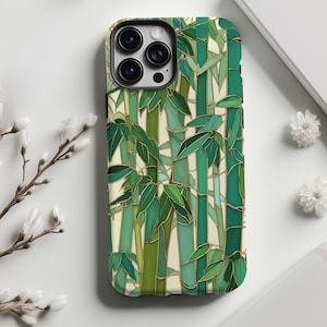 May include: A phone case featuring a vibrant bamboo design. The case showcases a mosaic-style pattern with shades of green and gold, depicting bamboo stalks and leaves. The design is set against a cream-colored background, creating a nature-inspired aesthetic.