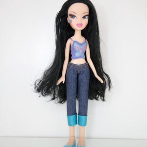 May include: A set of three ceramic mugs with a speckled, matte finish. Each mug features a different color: light blue, cream, and gray. The mugs have a simple, modern design and a comfortable handle.