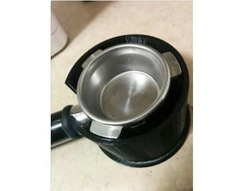 May include: A black 3D printed espresso portafilter holder with a silver portafilter inside.