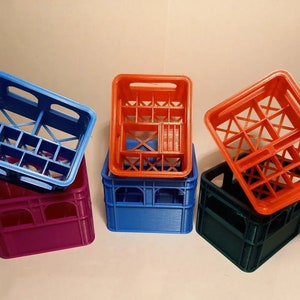 May include: Four empty plastic crates stacked on top of each other. The crates are blue, purple, green, and orange.