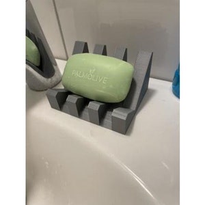 May include: A gray soap dish with a bar of green soap that says "PALMOLIVE" on it.