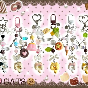 May include: Six decorative keychains featuring cat-shaped donut charms, white bows, and various miniature food and star-shaped pendants attached to metal clasps. The text "I LOVE CATS" and "777Art&Jewelz <3" is visible at the bottom of the image.