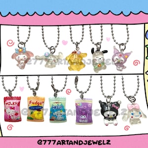 May include: A set of 10 colorful charms featuring cartoon characters and snack bags. The charms are on silver chains and are displayed on a pink and yellow background with the words "BAG CHARMS".
