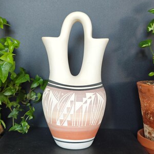 May include: A set of three ceramic mugs with a speckled, matte finish in cream, light brown, and dark brown. Each mug has a simple design and a rounded handle.