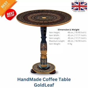 May include: Handmade coffee table with a gold leaf design. The round tabletop and base feature intricate patterns. The table is 18.90 inches high and 17.71 inches wide. The item weight is 4 kg. The text "HandMade Coffee Table GoldLeaf" is visible.