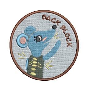 May include: A round, brown-edged embroidered patch with a light blue mouse with a pink ear and a green shirt with a yellow spine. The text "Back Block" is written in brown around the mouse.