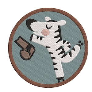 May include: A round, brown-edged patch with a white and black striped zebra holding a brown boxing glove. The zebra is smiling and has its eyes closed. The background is a light blue color.