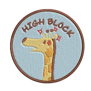 May include: A round, brown embroidered patch with a light blue background. The patch features a cartoon giraffe with a surprised expression and the text "HIGH BLOCK" in brown lettering.